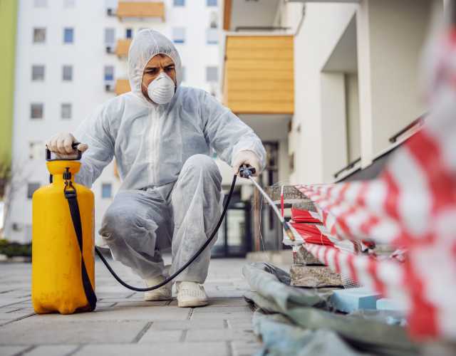 Worker sanitzing store shelves